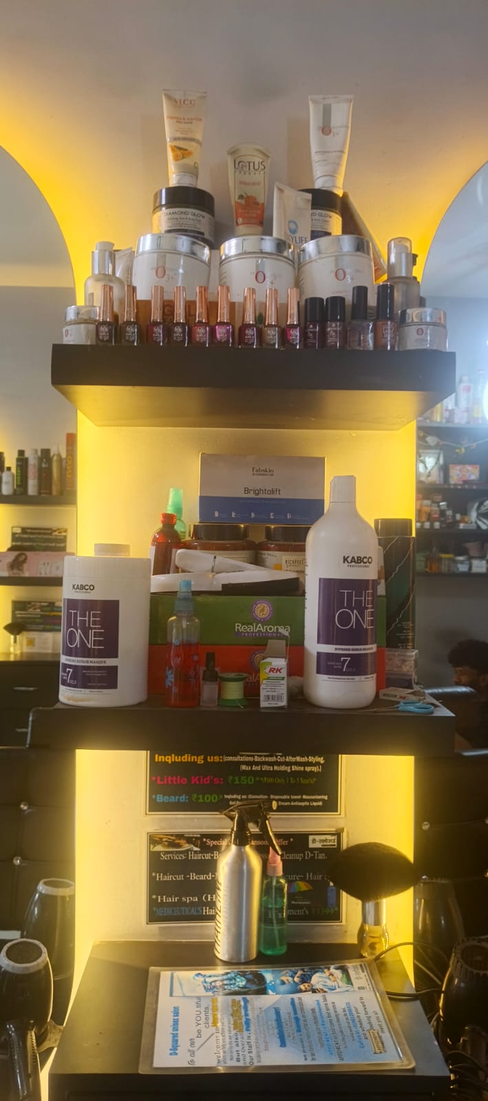 Illuminated product shelf with professional hair care brands at D Squared Unisex Salon